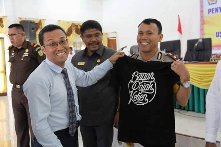 Penyerahan suvenir berupa baju bertuliskan "Bayar Pajak Keren" kepada beberapa pejabat Muspida